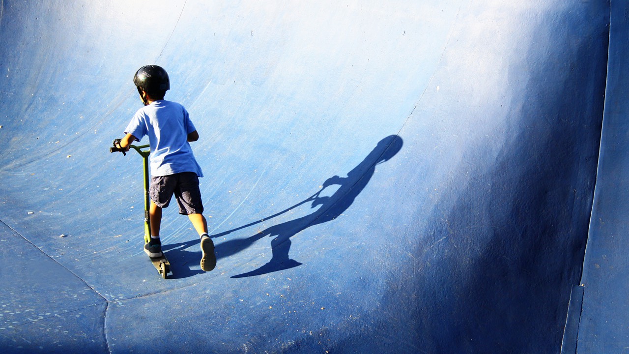 Kid with helmet on trickbike