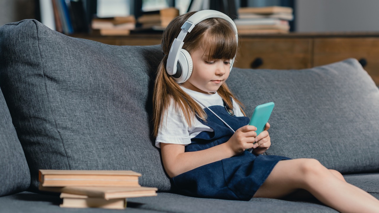 Headphones on girl looking on a smartphone